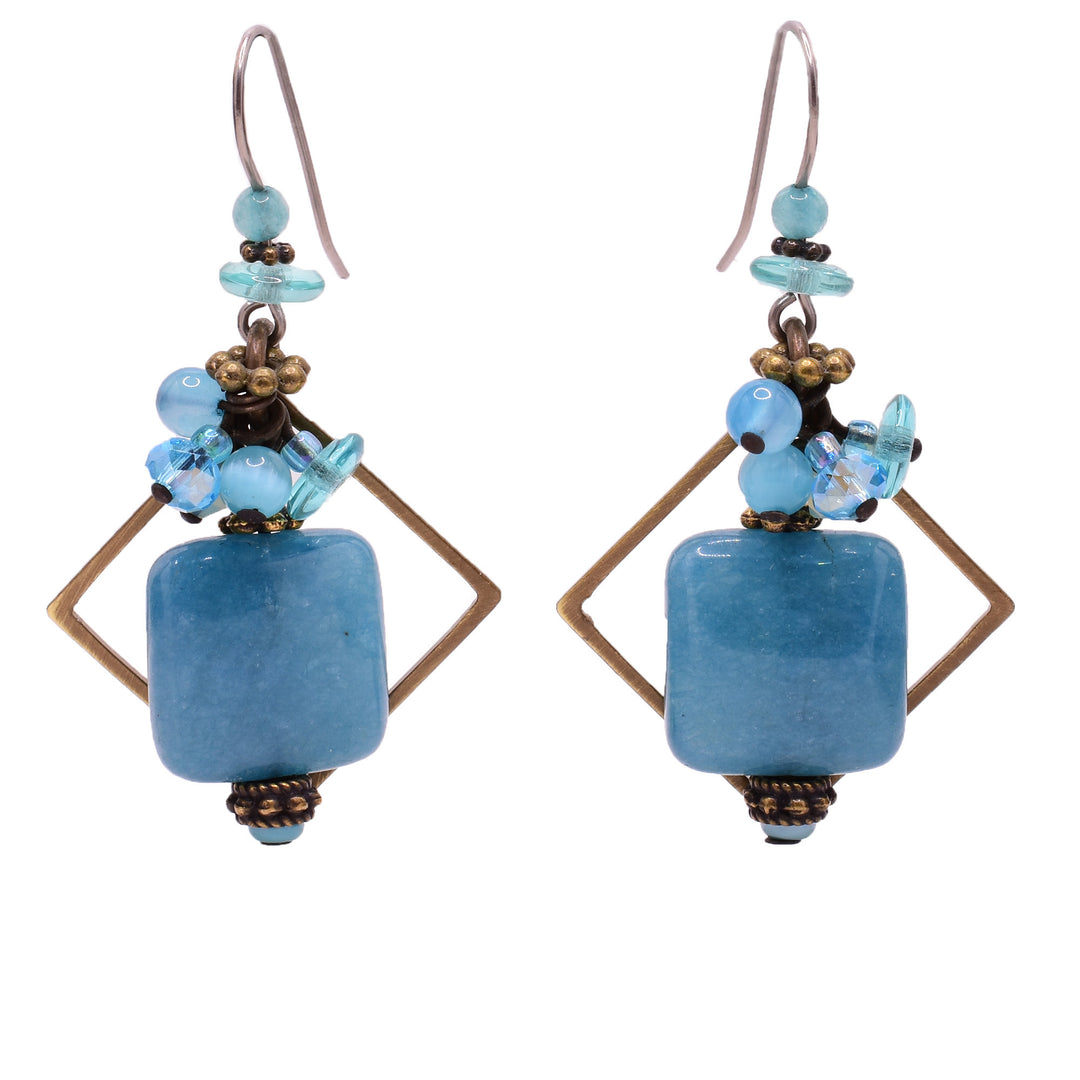 Blue dangle earrings made of Austrian crystal, dyed agate, blue quartz, handworked brass and glass. Titanium ear hooks. By Honica.