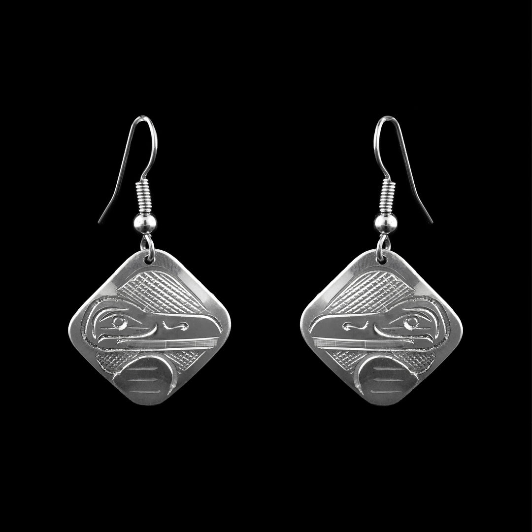 These dangle earrings are made from Sterling Silver shaped as dangle Squares with the legend of the Raven carved on the surface.