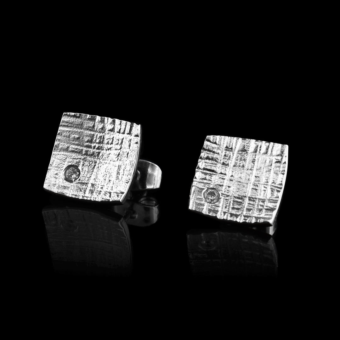 These Square Stud Earrings have been made with sterling silver and the bottom corner holds a cubic zirconia. 