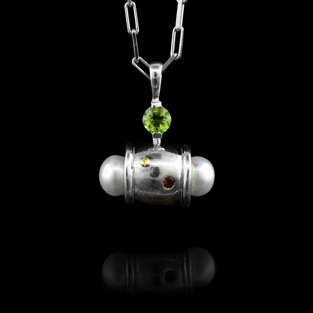 Ivan Dobren's handcrafted statement pendant. A stunning blend of freshwater pearls, sterling silver, green peridot, garnet, and 14k gold.