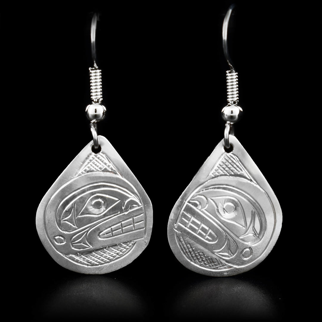 These dangling Orca earrings are made from sterling silver and has large, teardrop shaped hangs. There are depictions of the Orca carved into the surface of the hangs.