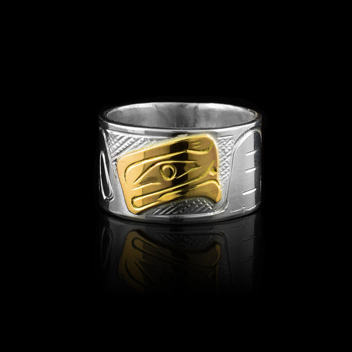this sterling silver and 10k gold band by artist Graham Henry. Featuring the Eagle legend hand-carved in solid gold against a detailed silver band,