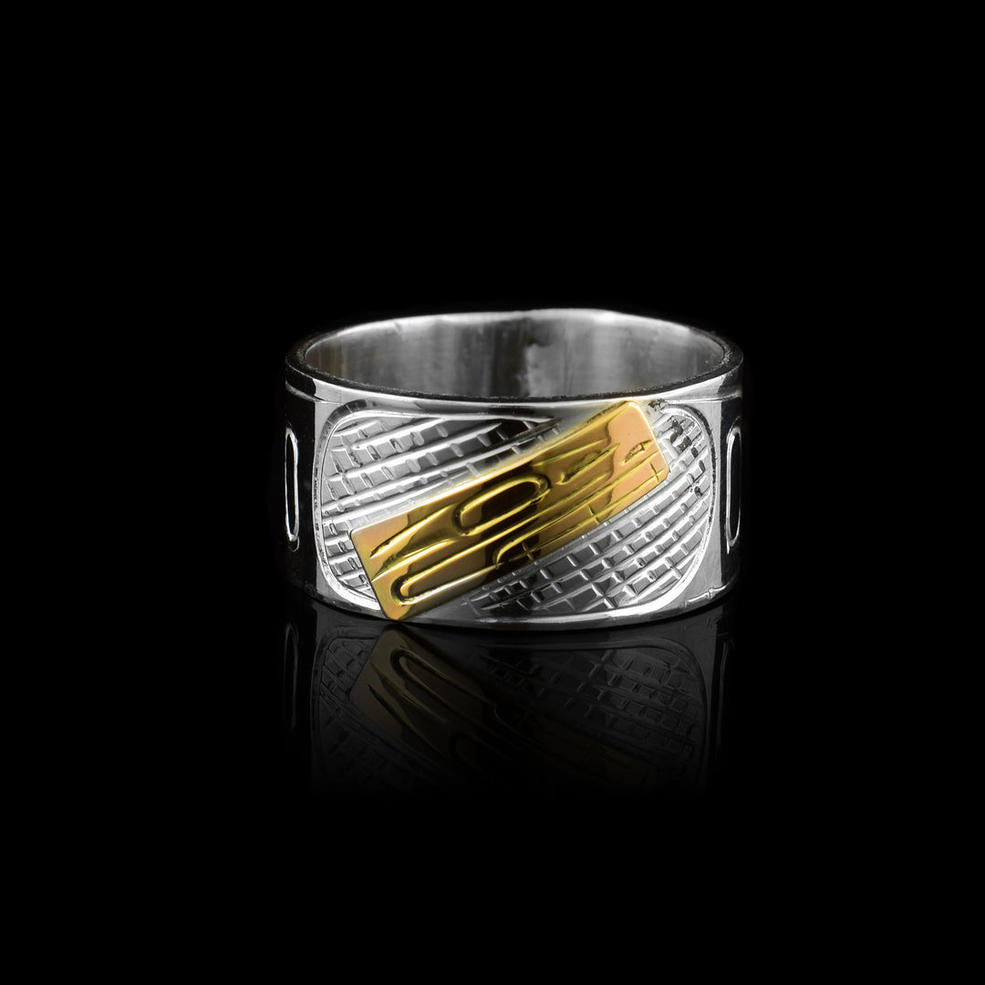 This sterling silver Orca band ring is hand-carved with a 10k gold center piece of the Orcas head.