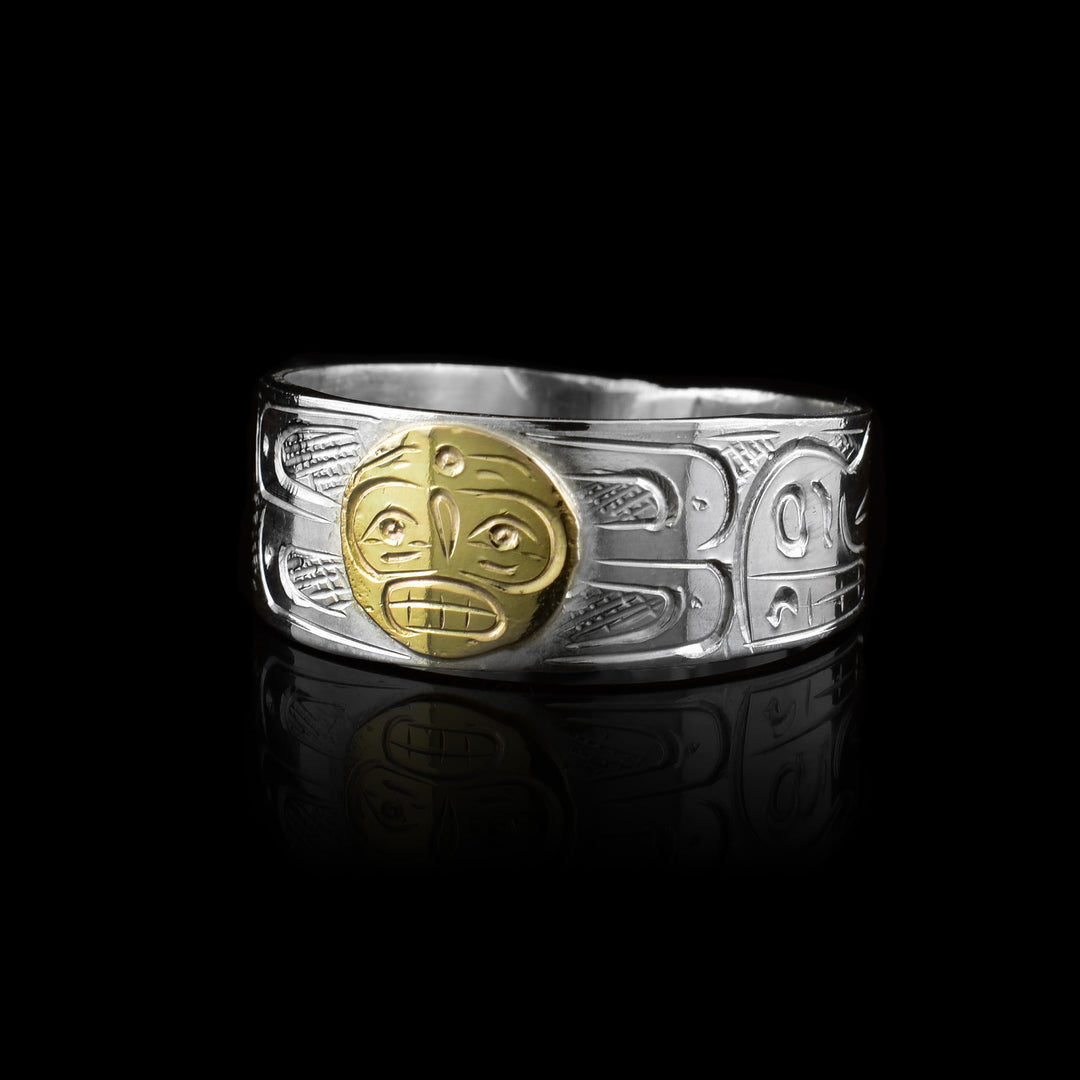 this sterling silver and 10k gold ring band by artist Graham Henry. The design features the Sun, Bear, and Wolf legends hand-carved into a solid 10k gold inlay for a bold, mixed-metal look.