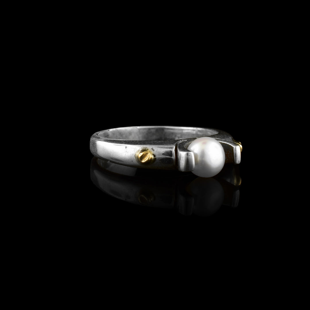 Sterling silver pearl ring featuring 14K gold accents, combining clean design with mixed-metal detail.