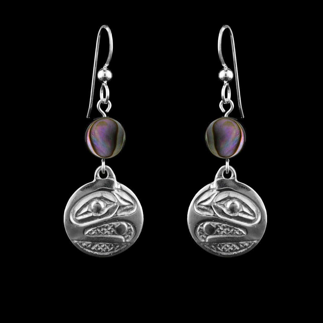 Sterling Silver Abalone Circle Raven Earrings. Little circles of abalone shell sit underneath the hooks and under the shells is a circular depiction of the Raven cast into sterling silver. 