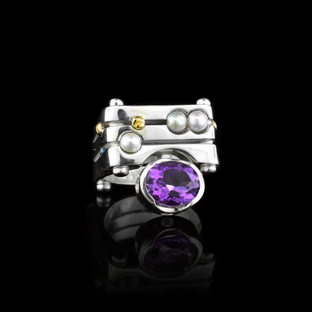 Handcrafted by artist Ivan Dobren, this striking square ring showcases a round amethyst framed by elegant pearls. The sterling silver square band is complemented by signature 14K gold screw accents, creating a contemporary yet modern design.