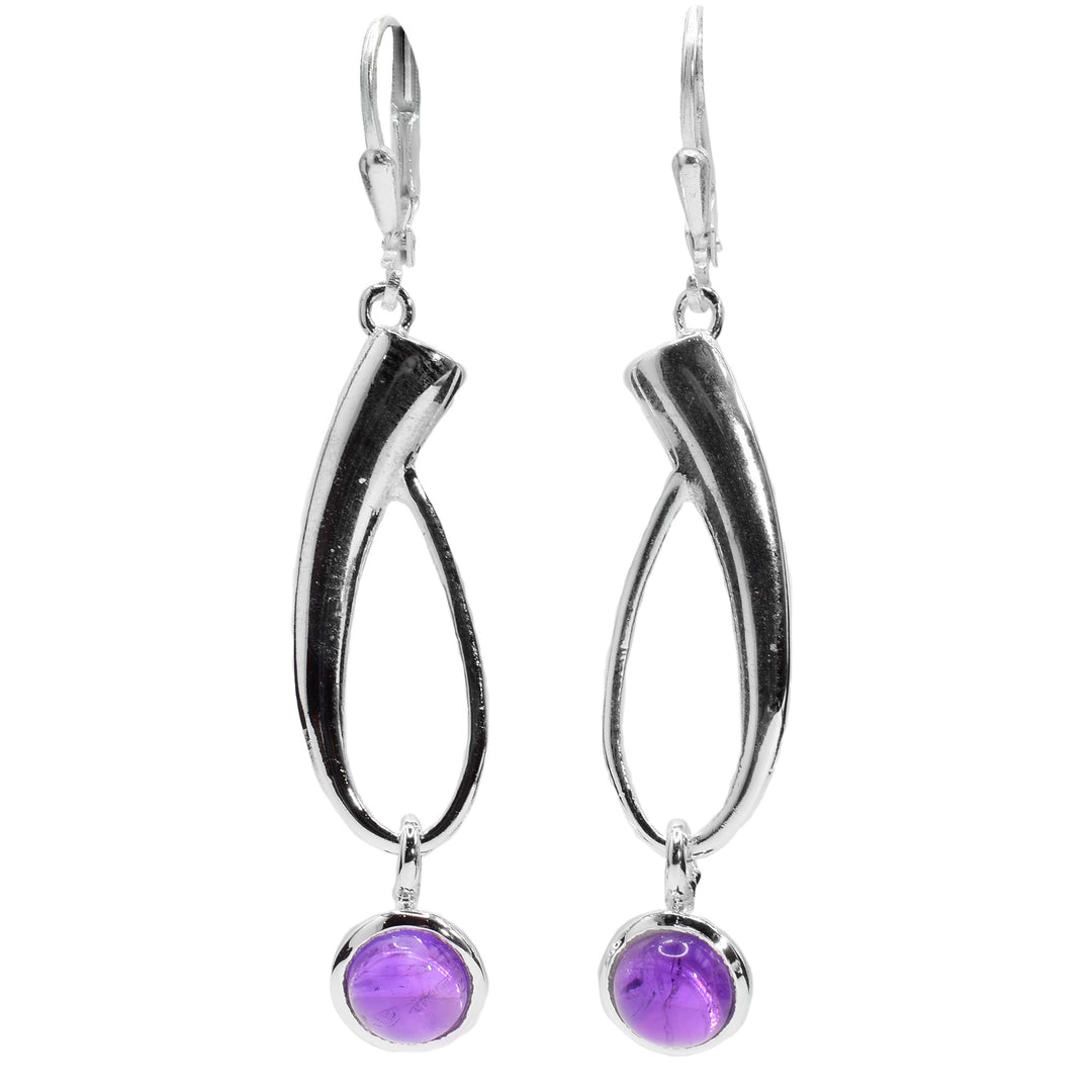 These gemstone drop earrings are made from sterling silver and amethyst gemstones. The hangs have long silver sections that are teardrop shaped hoops dangling from the hooks. There are circle gems dangling from the bottom of the silver hoops.