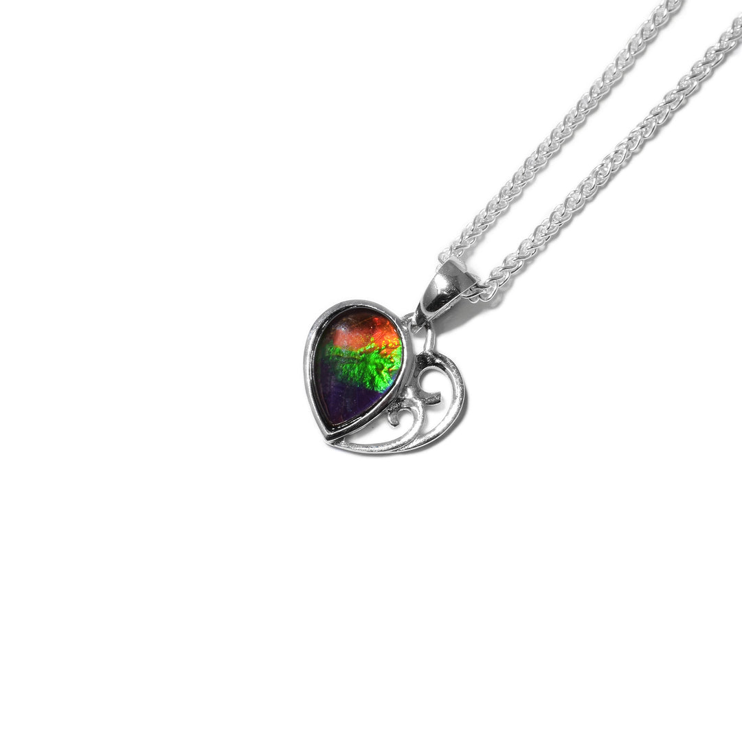 Heart-shaped pendant. Right side is a teardrop piece of AA-grade ammolite that is upside down. Other side is two sterling silver upward tendrils that end in swirls.