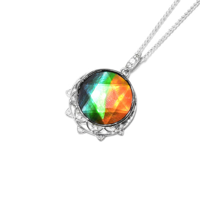Round, faceted AA-grade ammolite. Bottom has two rows of petal-like designs made of sterling silver wires. Petals have white topaz in them. Bail has white topaz as well.