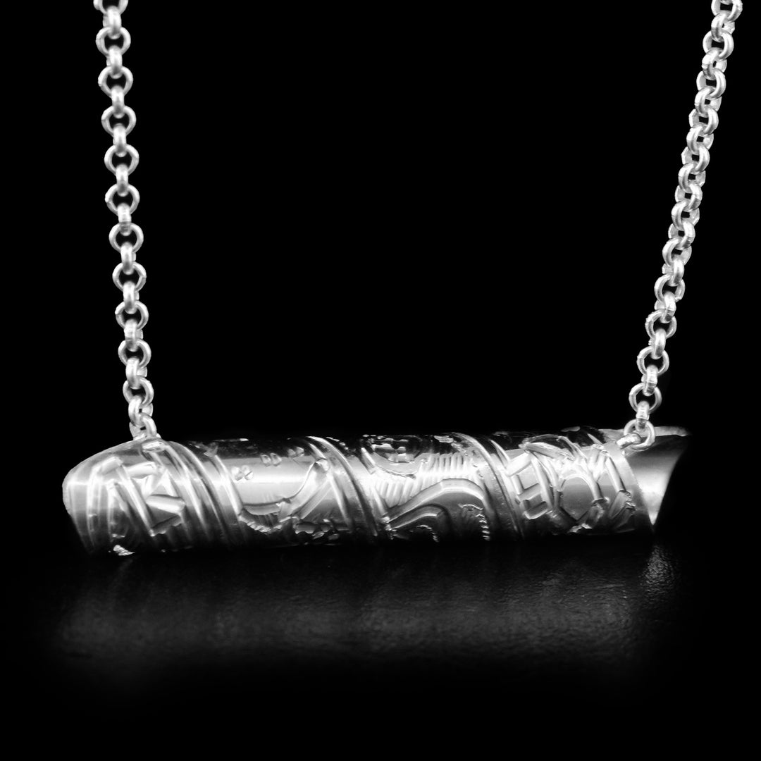 This Bear spiral pendant is made out of a sterling silver strip which has the face and body of the Bear carved on it and then coiled into a spiral.