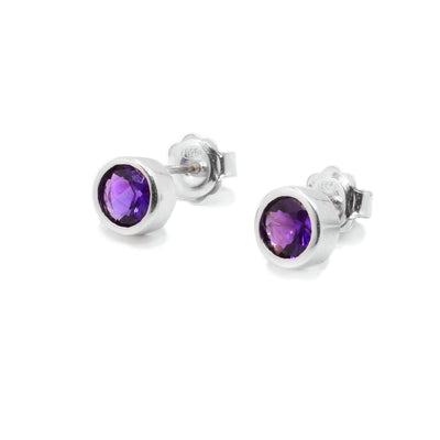 Round, petite, faceted amethyst stud earrings handcrafted by Ivan Dobren.