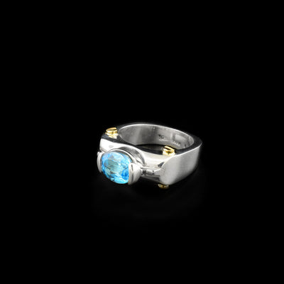 Sterling silver gemstone statement ring with blue topaz and dainty 14K yellow gold bolt adornments. Abstract design. By Ivan Dobren.