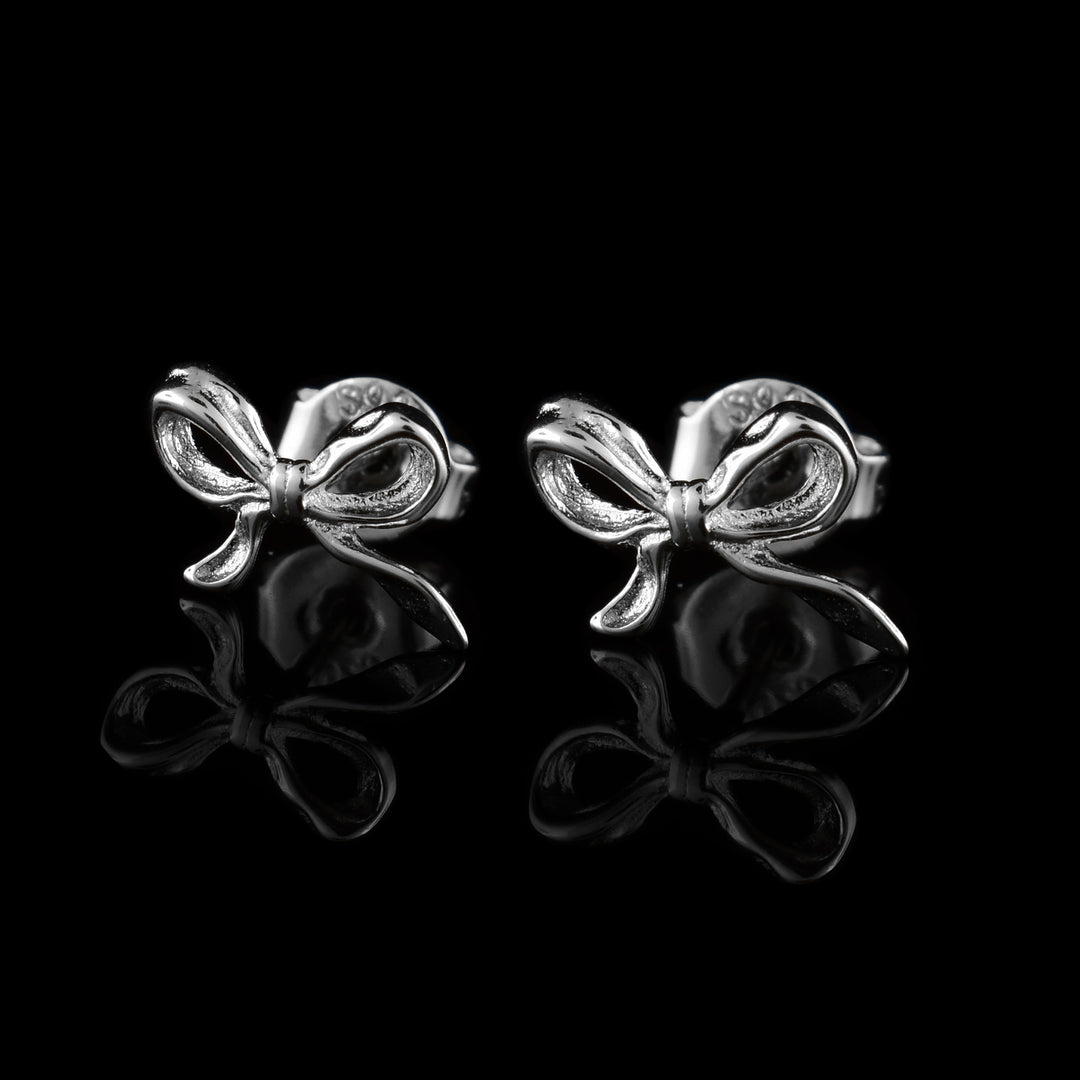 Shop our handcrafted sterling silver bow stud earrings. Featuring a polished ribbon design by our in-house artist.