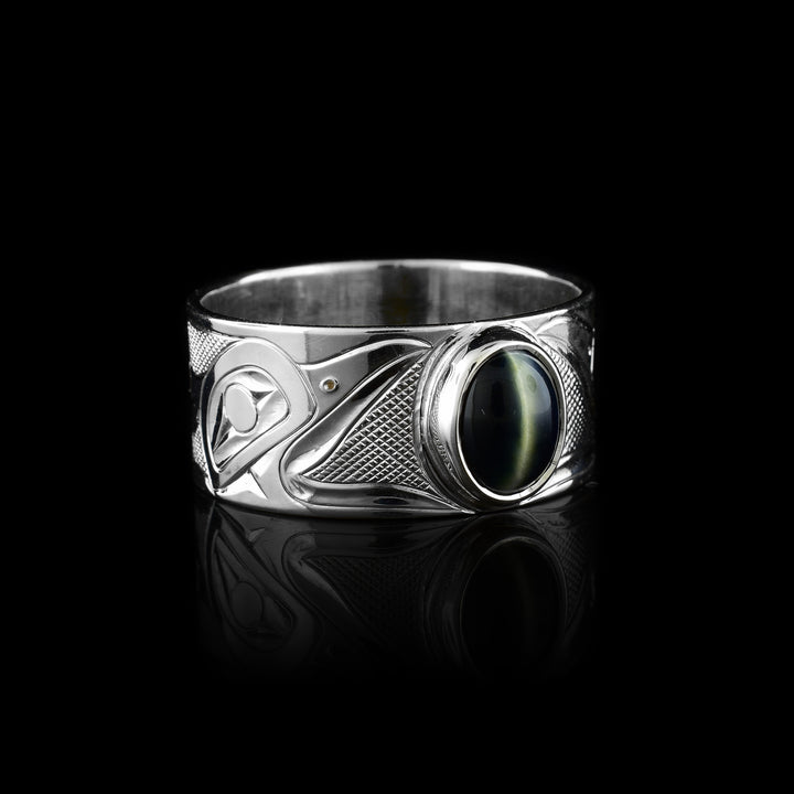 Shop this sterling silver Raven ring hand-carved by Tlingit artist Fred Myra. Featuring a striking circular cat’s eye stone in the middle of the ring and the legendary Raven head engraved on the band