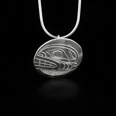 Sleek orca pendant hand-carved by Kwakwaka'wakw artist Don Lancaster. Made of sterling silver. Pendant is 1" in diameter. Hidden bail on back. Chain not included.
