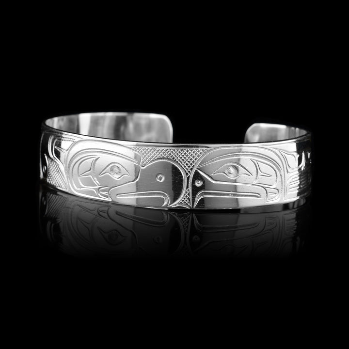 Sterling silver cuff bracelet hand-carved by Coast Salish artist Travis Henry, featuring the Thunderbird and Salmon legends. Authentic Indigenous jewelry.