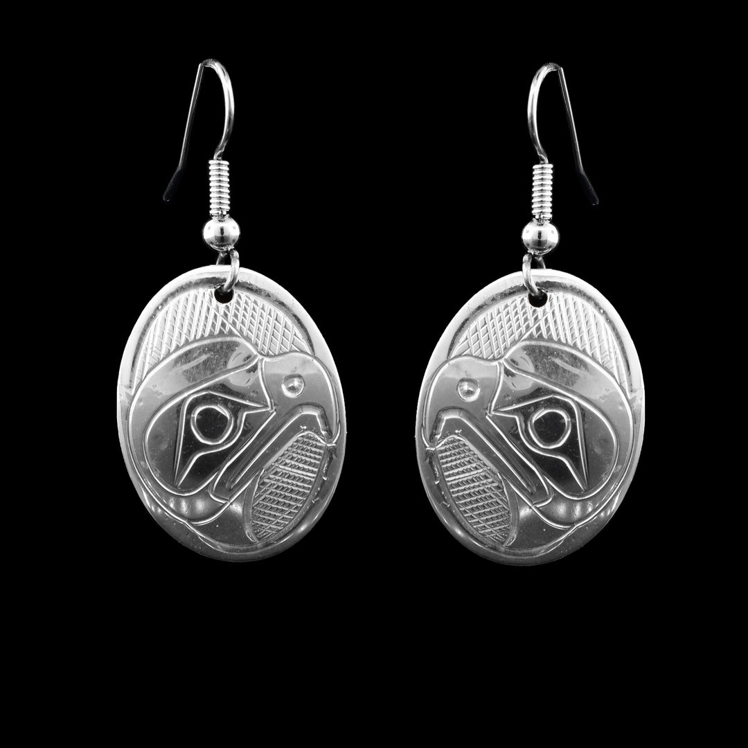 These Oval Sterling Silver Dangle Eagle Earrings are hand-carved with the legend of the eagle. They hang from french hooks.