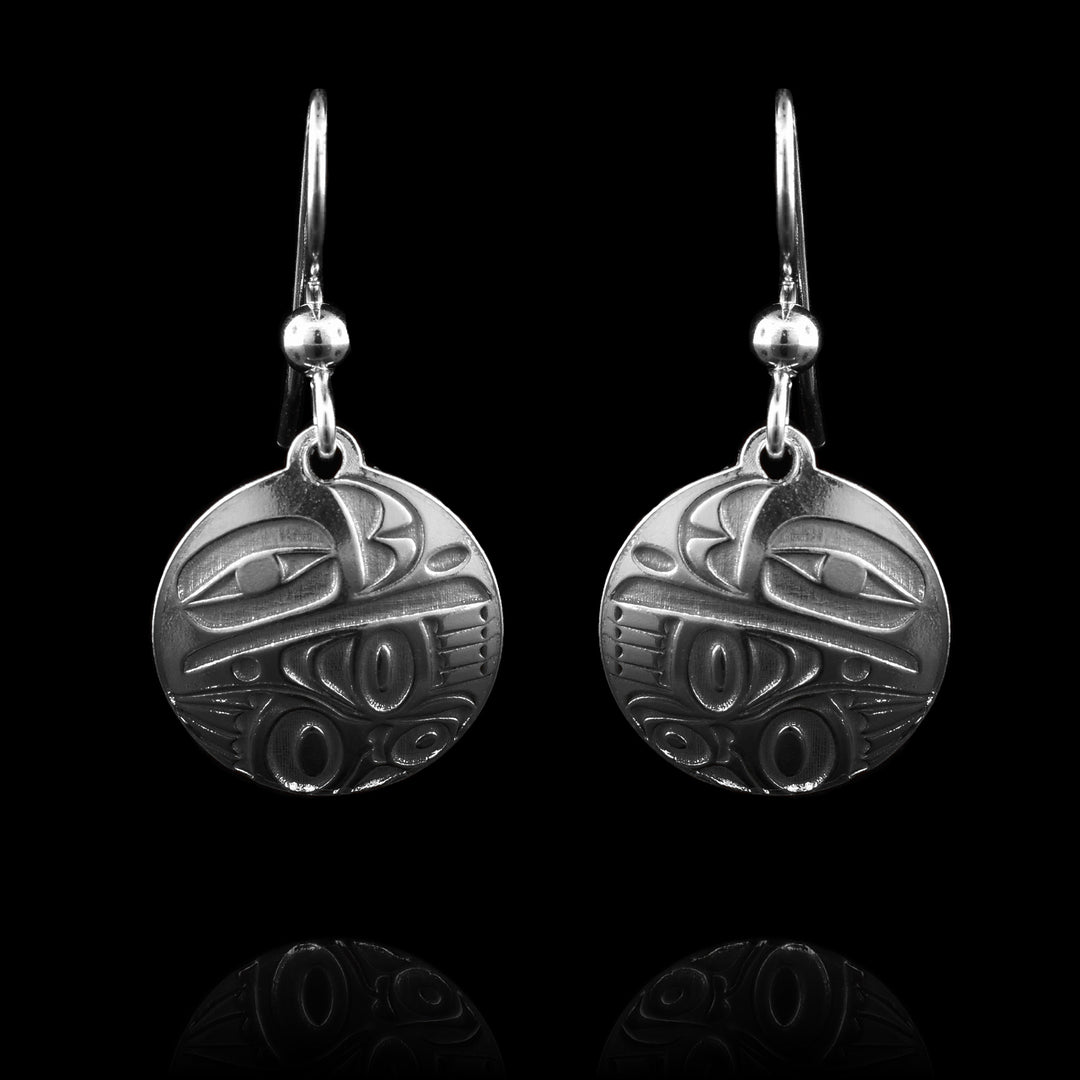 This dainty Raven sterling silver dangle earrings has a circle shape made from sterling silver. There is a depiction of the Raven cast into the earrings.