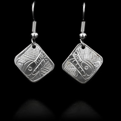 These sterlin silver earrings have hooks with diamond, shaped hangs attached to them. The diamonds have the face of the Wolf handcarved onto them.