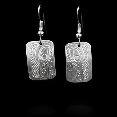 These sterling silver earrings have hooks that have rectangular hangs. The hangs depict the face of the Wolf.