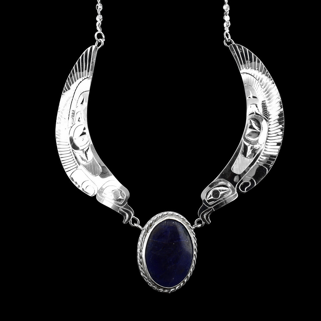 This Sterling Silver Double Eagle Wing Necklace with Lapis Lazuil. The legend of the eagle is on either side of the large stone lapis that sits in the middle.