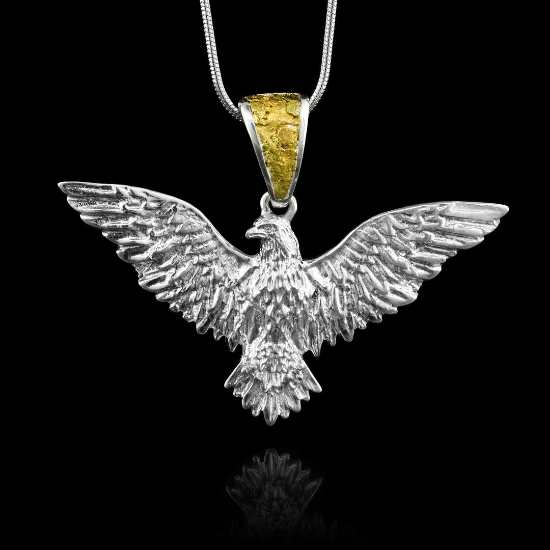 Shop our Sterling Silver Eagle in Flight Pendant at Artina's. Features meticulous handcrafted detailing and a luxury bail inlaid with raw 22K gold nuggets.