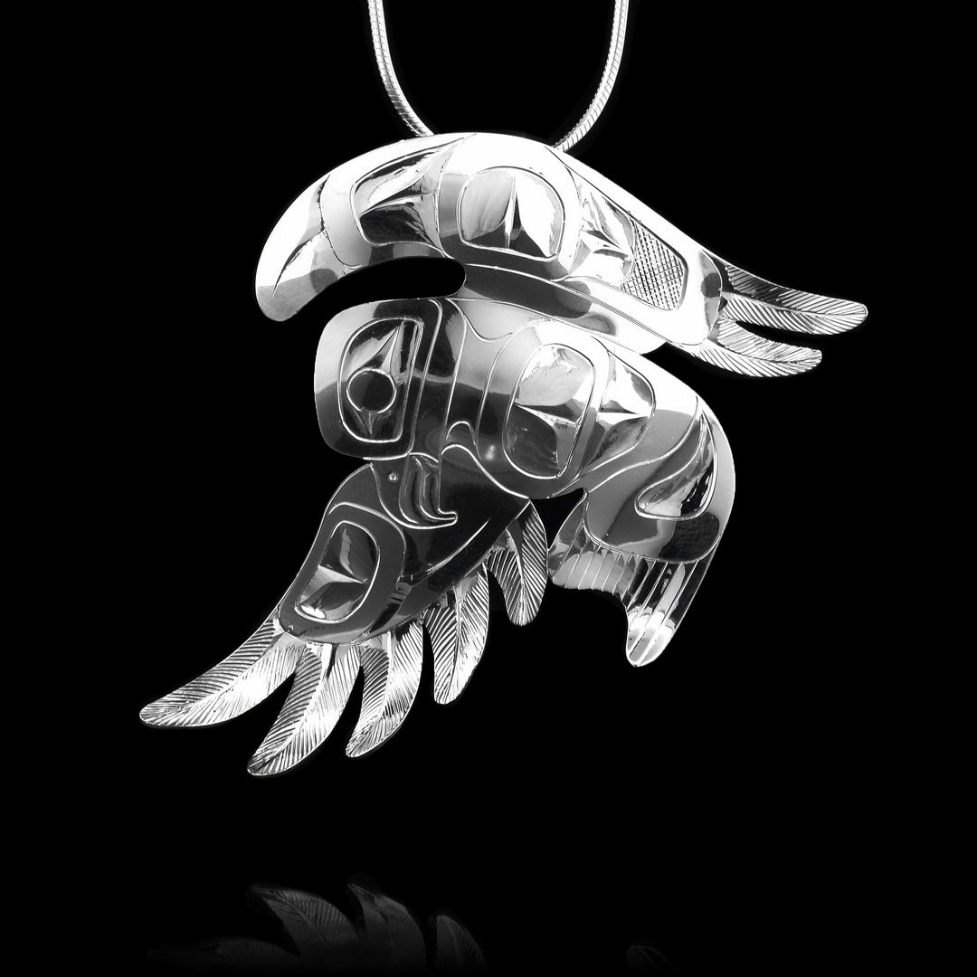 Handcrafted sterling silver eagle pendant featuring Northwest Coast Indigenous design. Symbol of strength, vision, and freedom. Made in Canada.