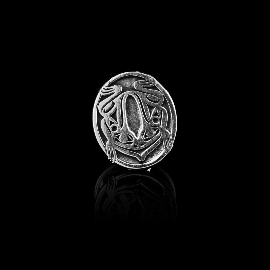 Sterling Silver Frog Pin the legend of the frogs body is carved into the silver circle.