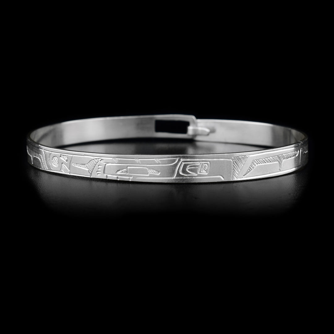 This sterling silver Thunderbird bracelet depicts the face of the Thunderbird on the front. The body of the Thunderbird is depicted around the rest of the bracelet. There is a clasp on the back.