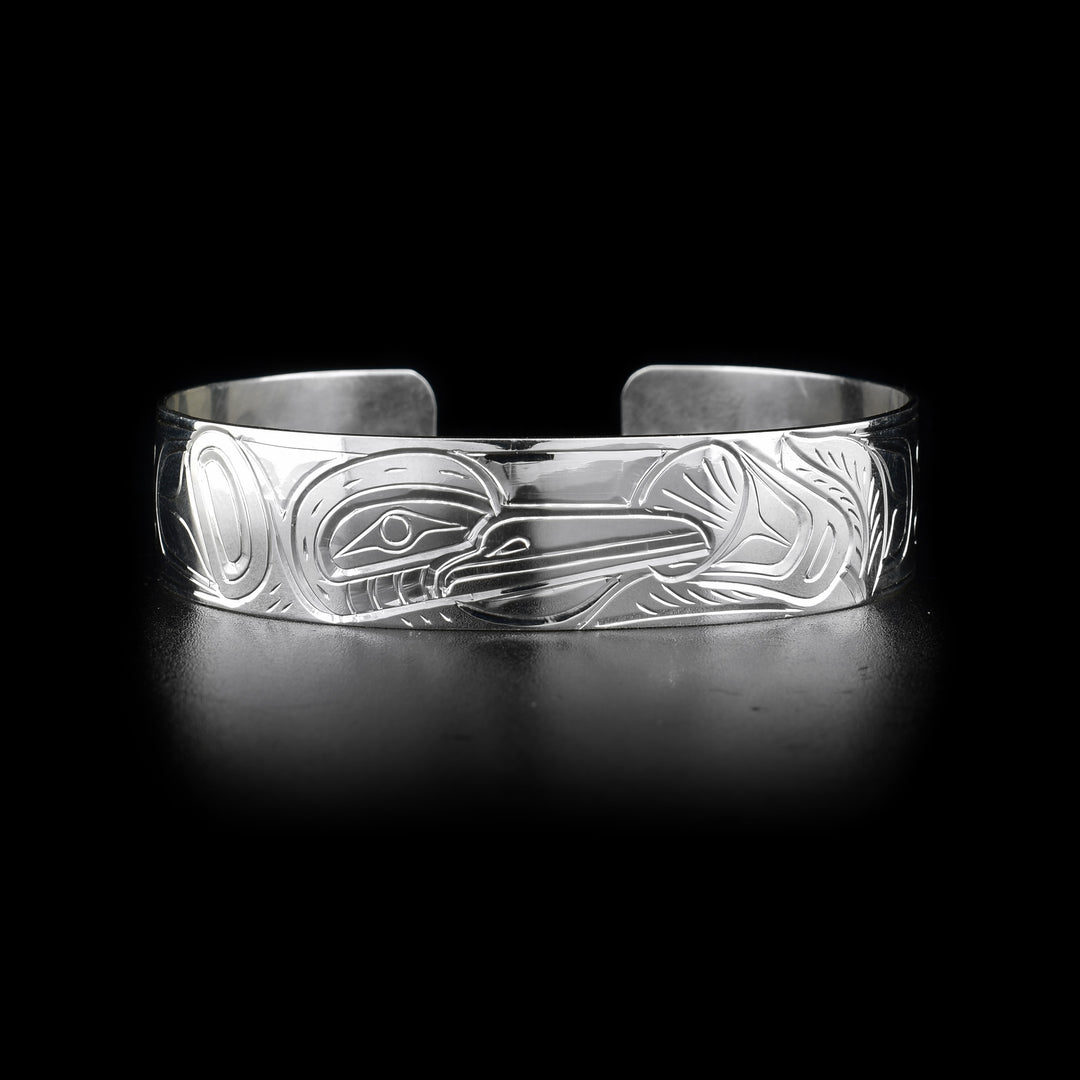 This Hummingbird bracelet has a single, sterling silver band with a gap in the back. There is a depiction of the Hummingbird carved into the surface of the band.