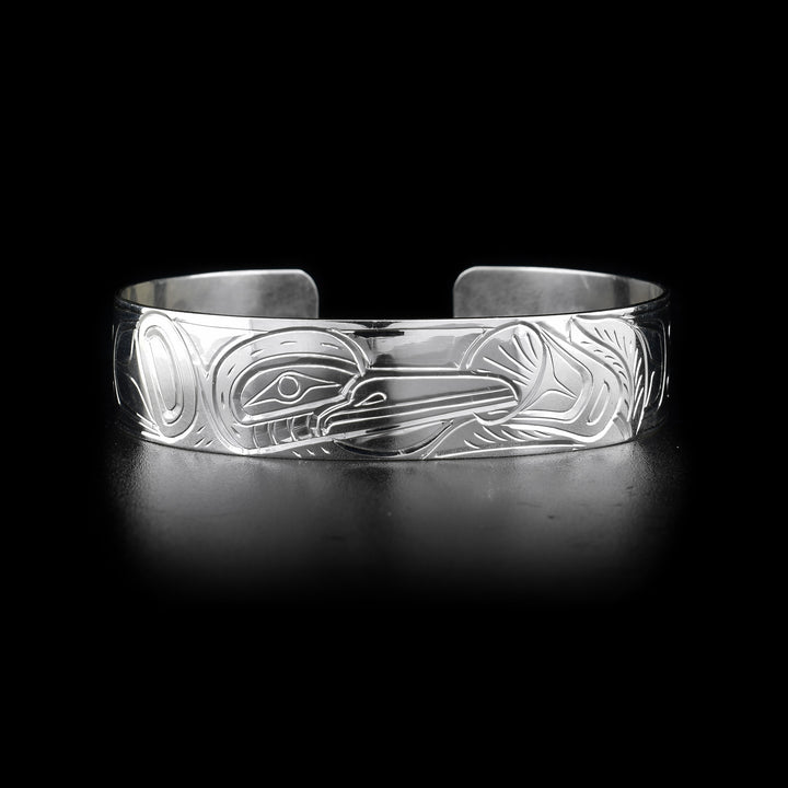 This Hummingbird bracelet has a single, sterling silver band with a gap in the back. There is a depiction of the Hummingbird carved into the surface of the band.