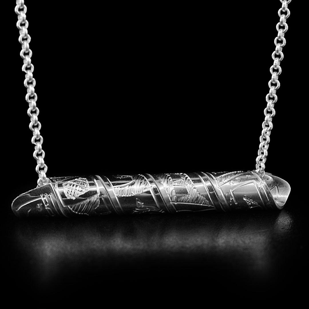 This pendant is made out of a sterling silver strip which has the face and body of theBear carved on it and then coiled into a spiral.