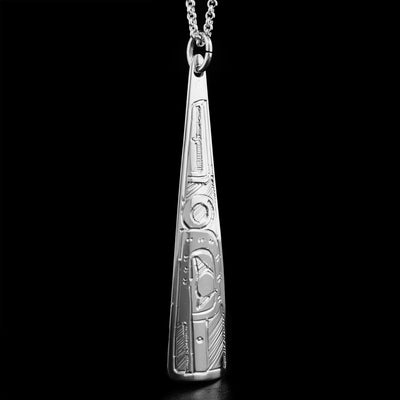 This sterling silver pendant has a long triangle shape and has the face of  the  Hummingbird handcarved on it, facing downwards.