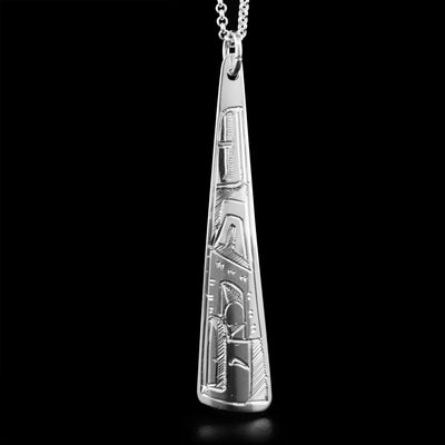 This pendant is made out of sterling silver. It has the shape of a long triangle. The face of the Eagle is carved on it, facing downwards.
