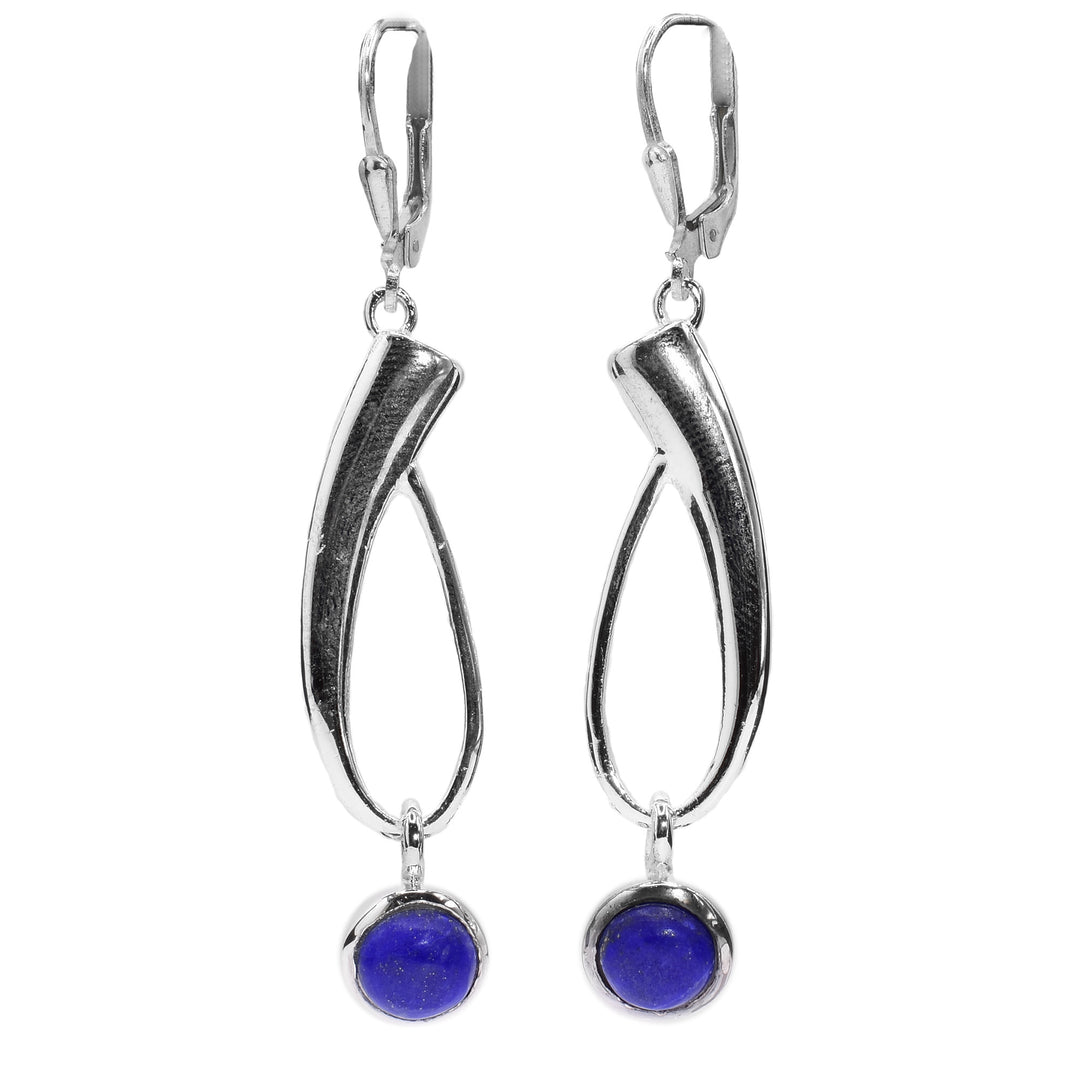 These dangling gemstone drop earrings are made from sterling silver and lapis lazuli. The hangs have long silver sections that are teardrop shaped hoops dangling from the hooks. There are circle gems dangling from the bottom of the silver hoops.