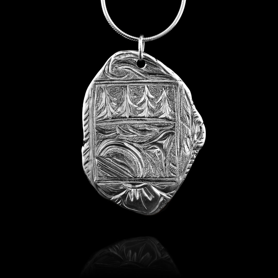This Sterling Silver Orca Box Pendant has the classic look of stamped metal like candle wax seal. The detail inside is and indigenous style orca swimming through the ocean with pine trees in the distance. 