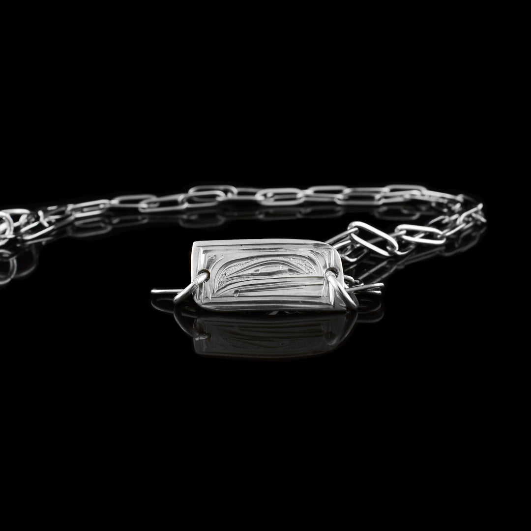 Handcrafted orca chain necklace featuring detailed sterling silver engraving orca head engraved in a small rectangular pendant on a chain.