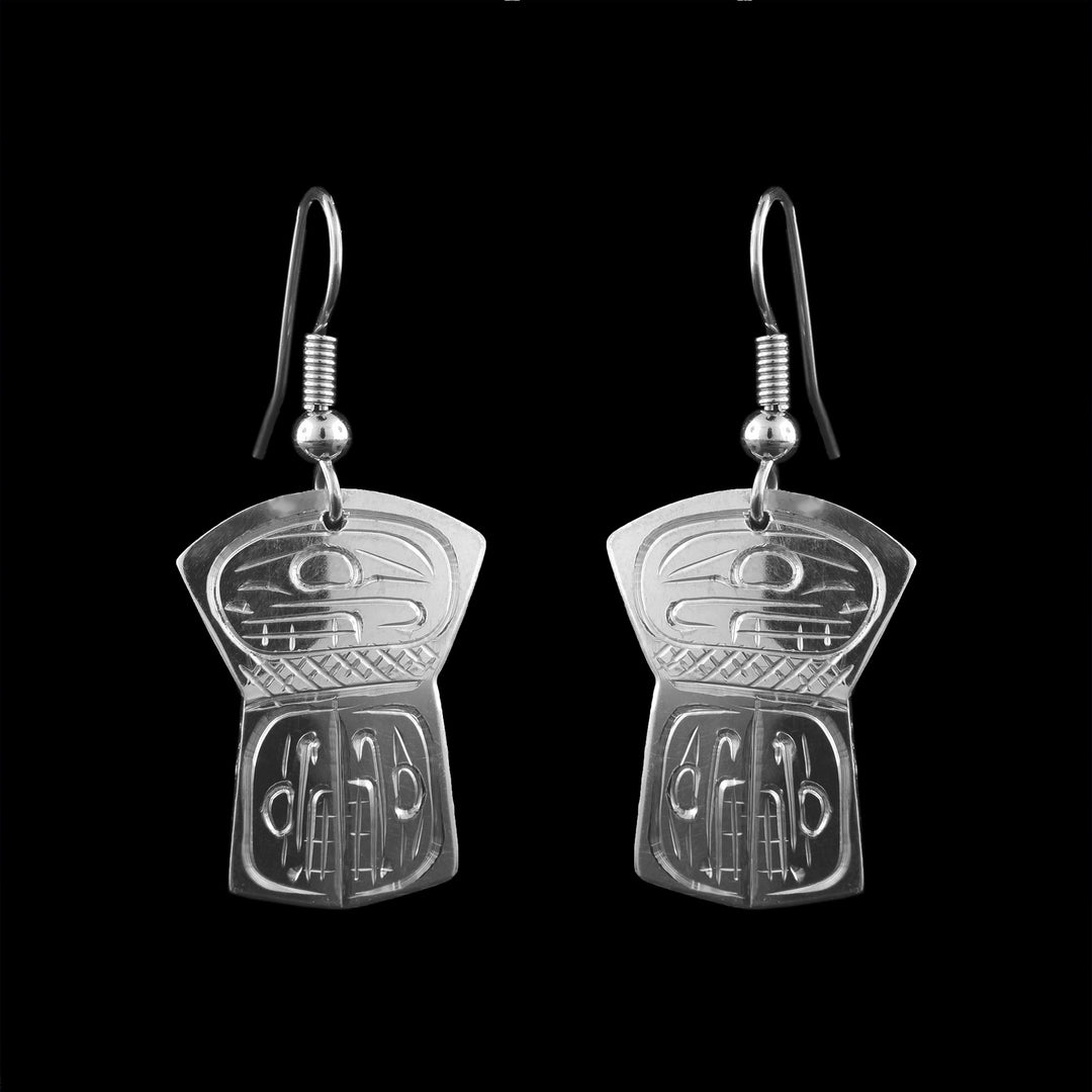 These sterling silver shield earrings, handcrafted by Coast Salish artist Graham Henry, showcase the intricate legend of the Orca. The unique dangle design highlights the fine formline engraving and the cultural heritage of the Pacific Northwest.