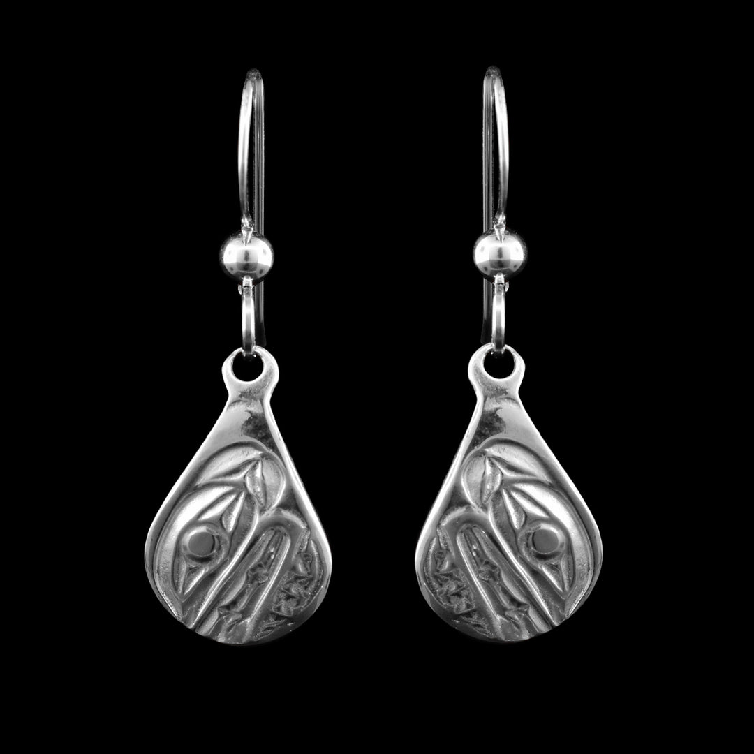 These sterling silver teardrop dangle earrings have been carved with the legend of the orca. 