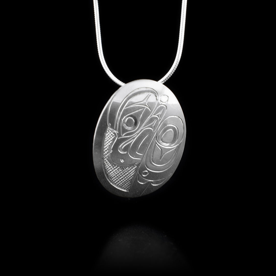 This Eagle pendant is made using sterling silver and has a slightly convex, oval shape. There is a depiction of the Eagle that has been intricately carved into the surface of the piece.