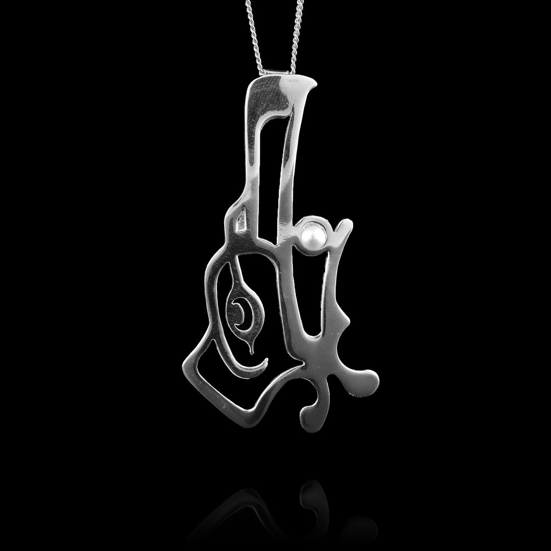 This sterling silver Raven pendant by Haida Gwaii artist Gina Mae Schubert. Handcrafted from sterling silver with a pearl accent in the mouth, this large statement piece combines traditional design with durable materials.