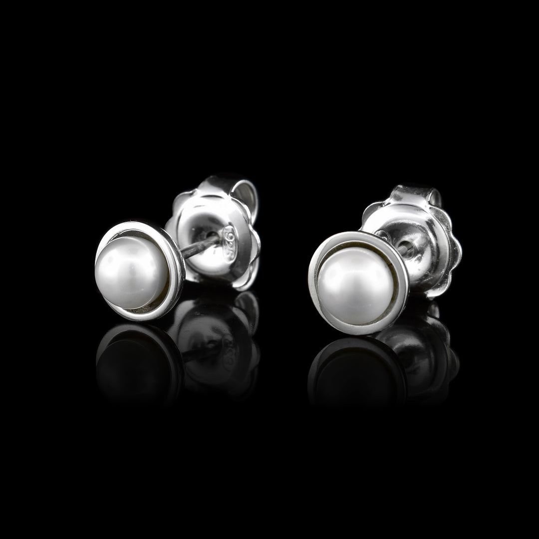 These pearl stud earrings have fresh water pearls held in sterling silver prongs.