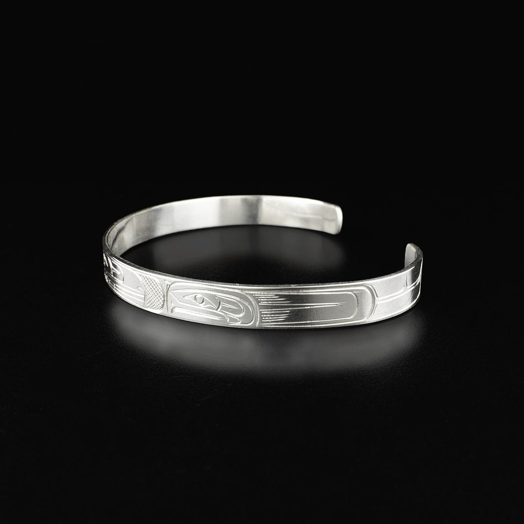 Side of cuff bracelet depicting side-view of salmon’s face.