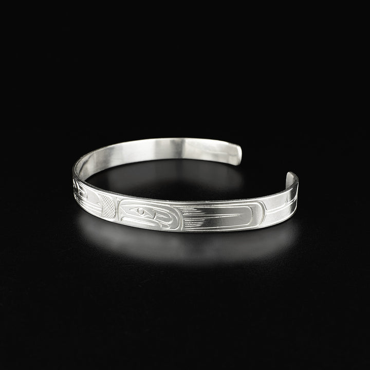 Side of cuff bracelet depicting side-view of salmon’s face.