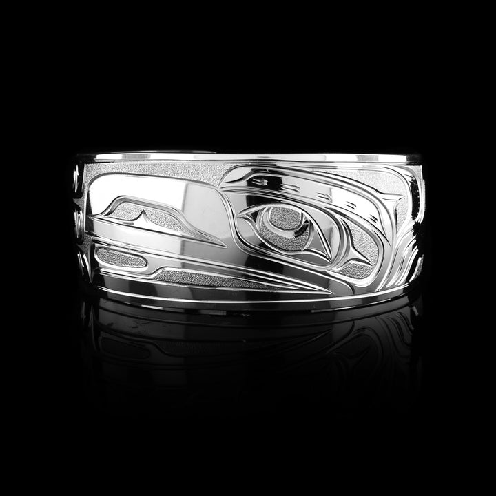 this Joe Descoteaux sterling silver Raven bracelet. Hand-carved with intricate Indigenous detail, this 1" cuff