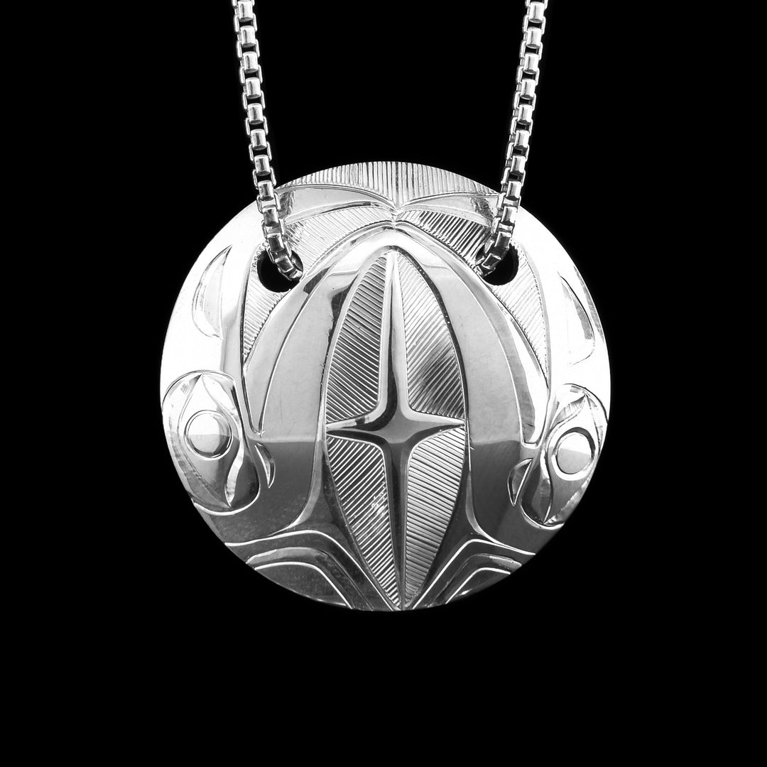Sterling Silver Raven Circle Pendant Necklace. Hand-carved by Haisla artist Hollie Bartlett, this sterling silver Raven pendant highlights traditional artistry in a refined, modern design.