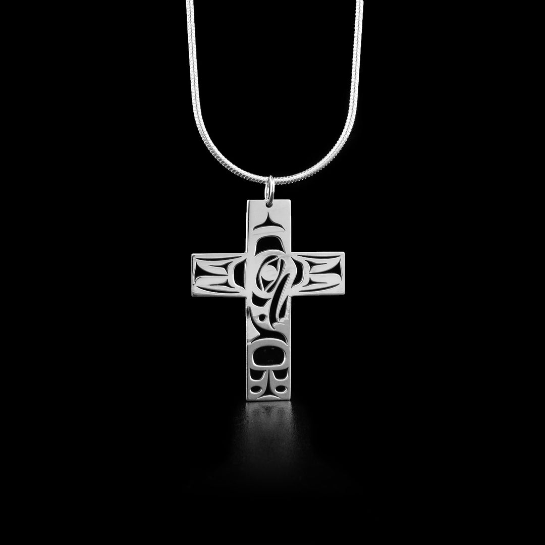 This raven pendant depicts the sideview of a raven's head facing downwards in the center. Parts of the pendant have been cut out to represent feathers.