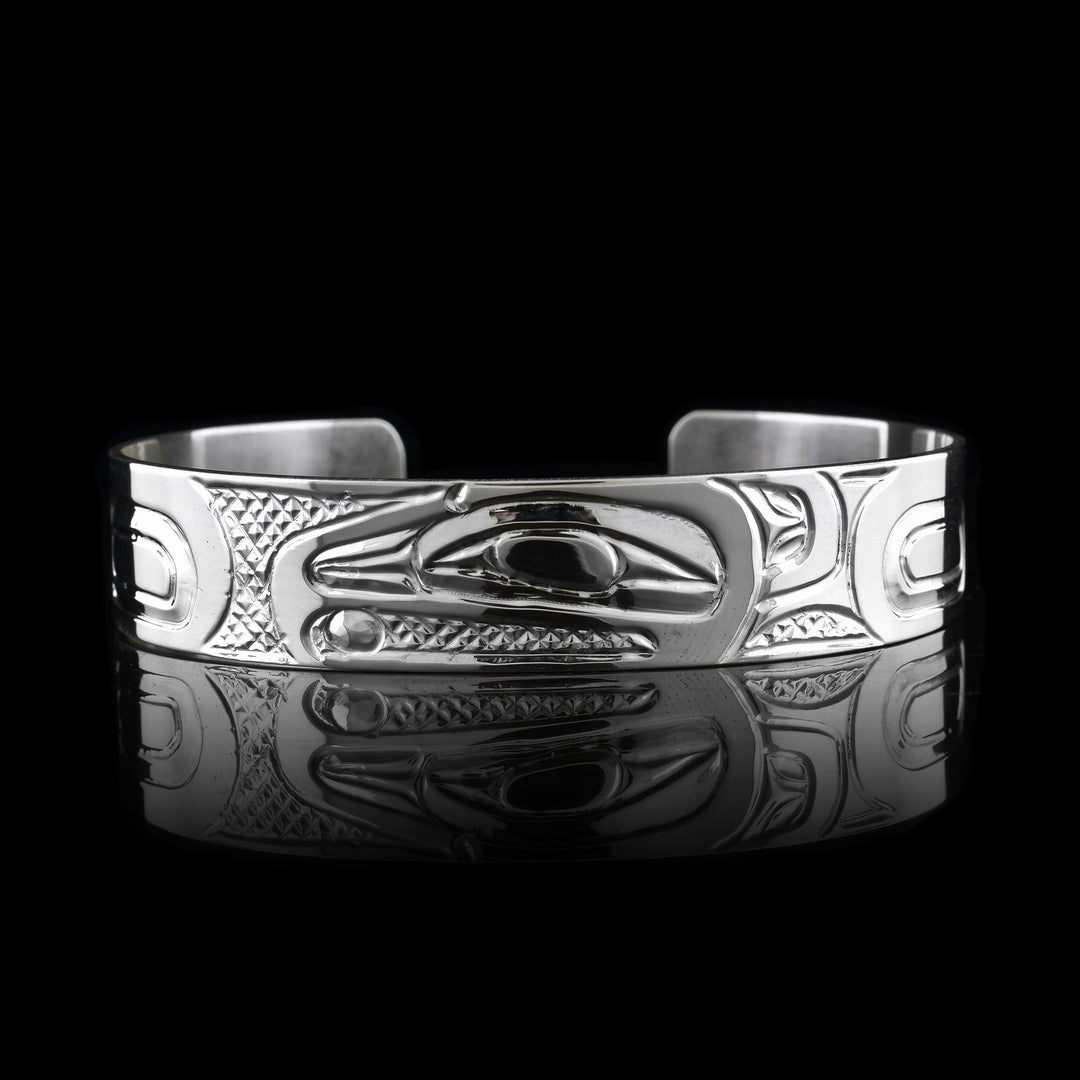 Handcrafted Raven Cuff in sterling silver, featuring intricate Indigenous engravings that honor the Raven’s head.