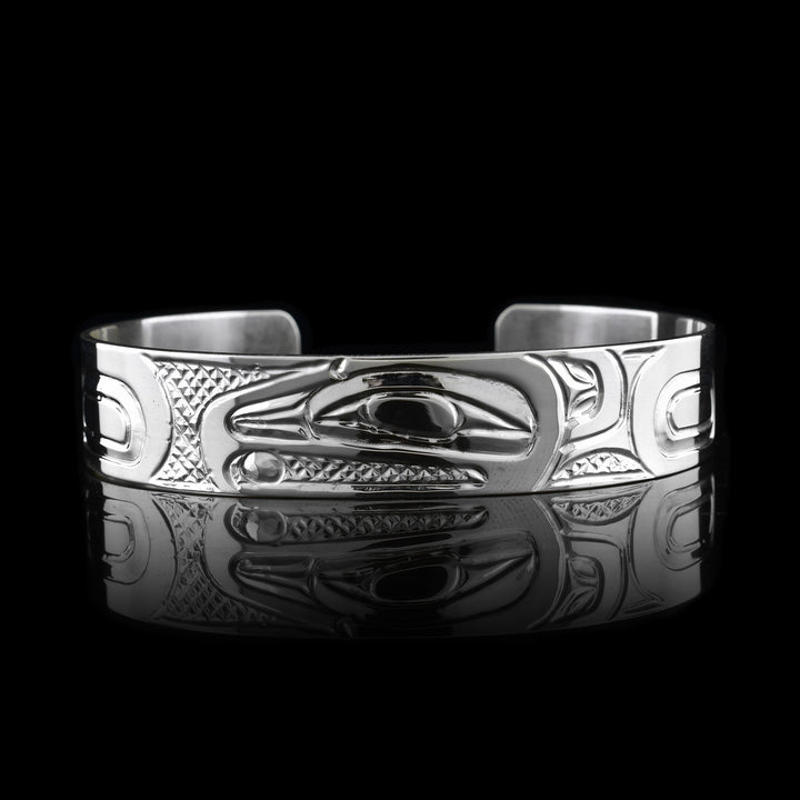 Handcrafted Raven Cuff in sterling silver, featuring intricate Indigenous engravings that honor the Raven’s head.